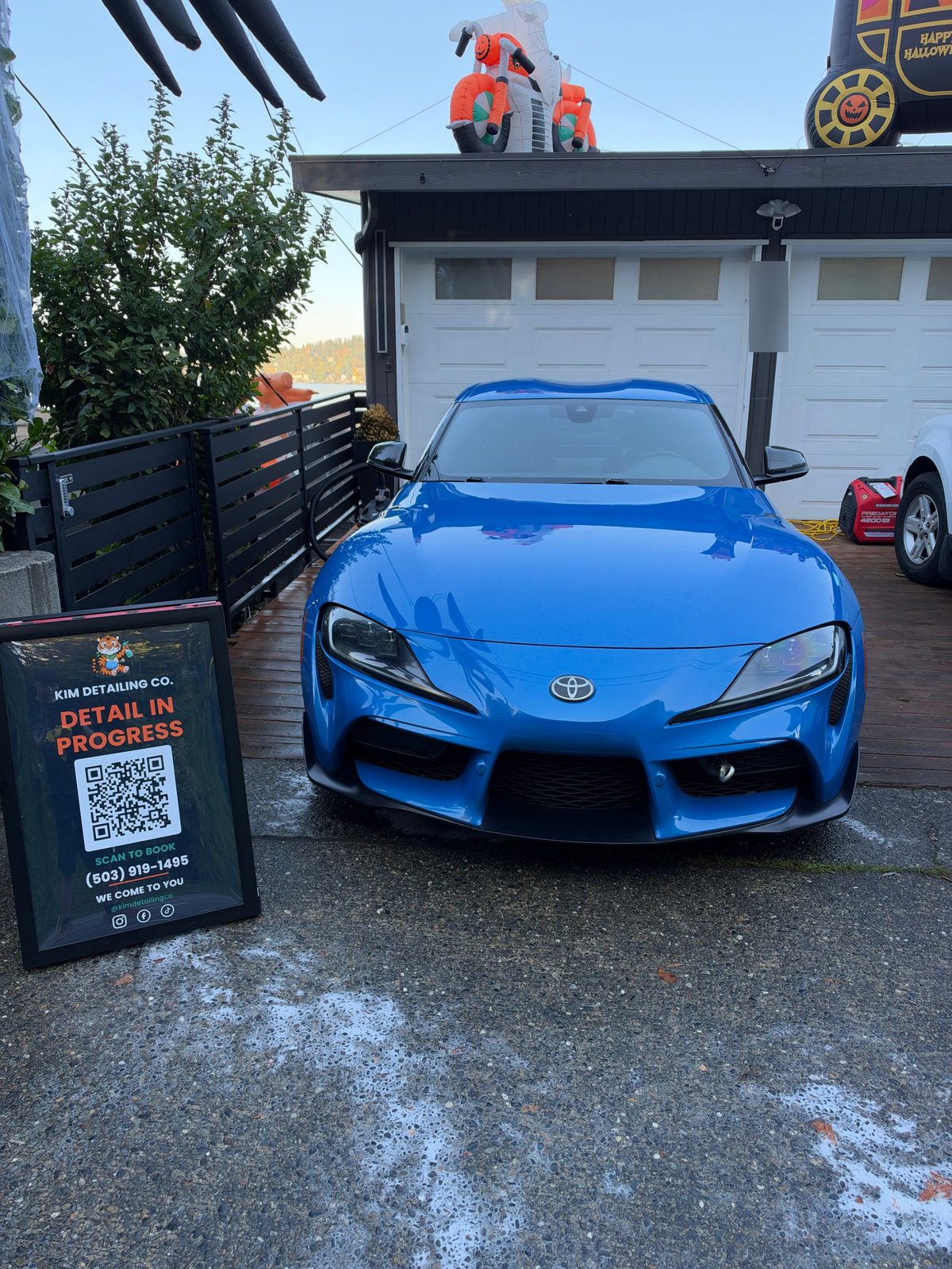 Blue Toyota GR Supra after a hand wash and ceramic sealant in a Seattle driveway